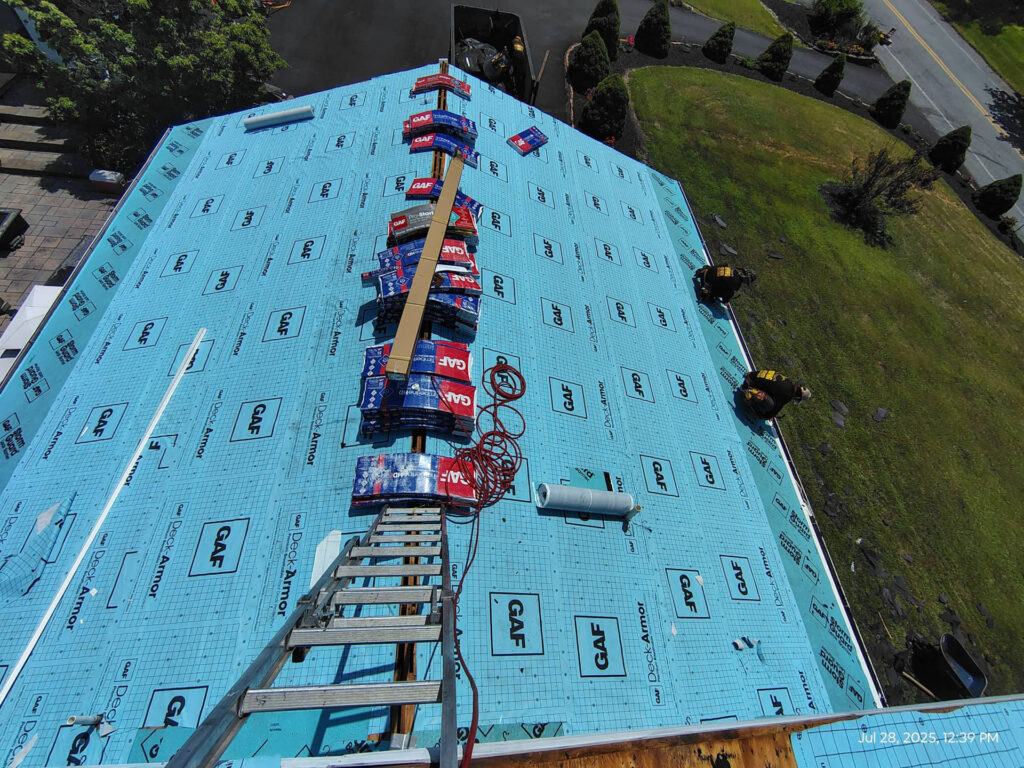 Roofing contractors replacing roof in the Poconos